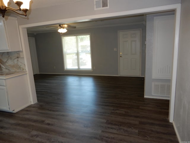 100 Douglas, Judsonia, AR 72180 - unfurnished living room featuring a chandelier, dark wood-style flooring, a ceiling fan, and baseboards
