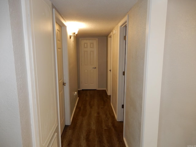 100 Douglas, Judsonia, AR 72180 - hallway featuring dark wood-type flooring, baseboards, and a textured ceiling