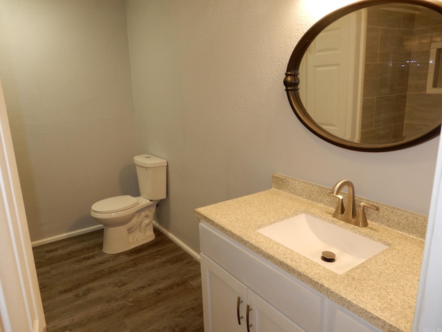 100 Douglas, Judsonia, AR 72180 - bathroom with vanity, wood finished floors, toilet, and baseboards