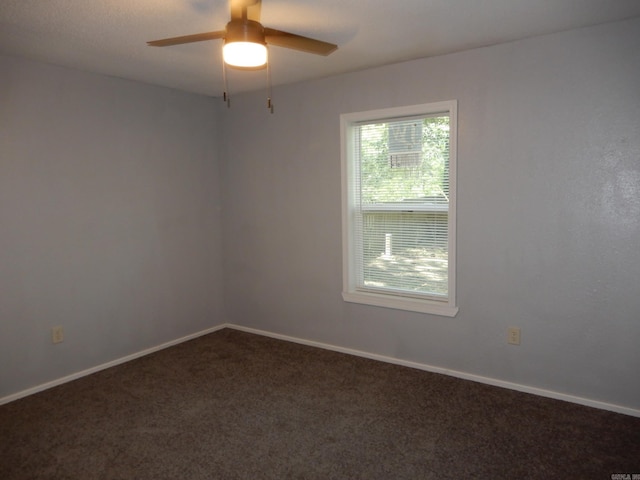100 Douglas, Judsonia, AR 72180 - empty room featuring dark colored carpet, ceiling fan, and baseboards