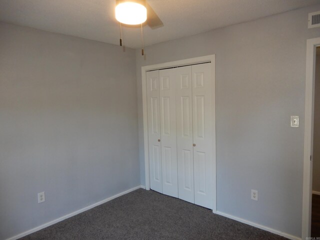 100 Douglas, Judsonia, AR 72180 - unfurnished bedroom featuring dark carpet, a closet, baseboards, and ceiling fan