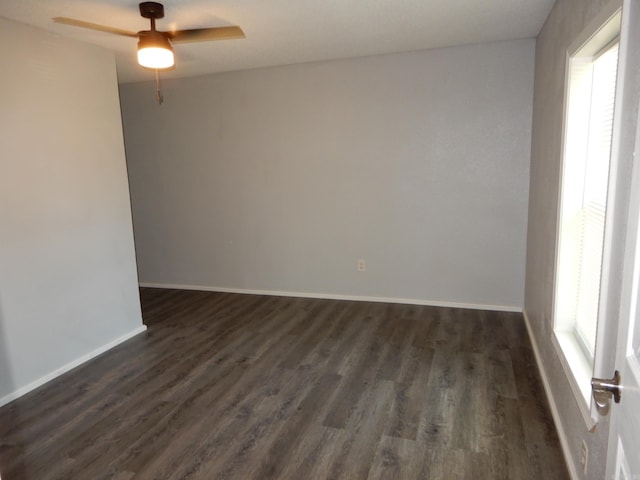 100 Douglas, Judsonia, AR 72180 - spare room with plenty of natural light, ceiling fan, dark wood finished floors, and baseboards