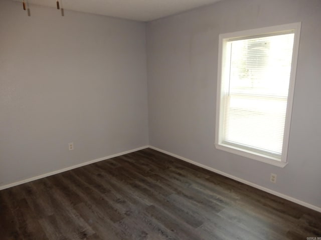 100 Douglas, Judsonia, AR 72180 - unfurnished room featuring dark wood-type flooring and baseboards
