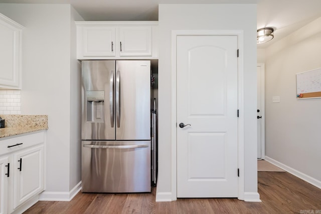 1324 Hunter Wood, Bryant, AR 72022 - kitchen with stainless steel refrigerator with ice dispenser, wood finished floors, baseboards, white cabinets, and light stone countertops