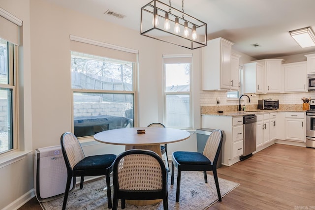 1324 Hunter Wood, Bryant, AR 72022 - dining area with light wood finished floors and baseboards