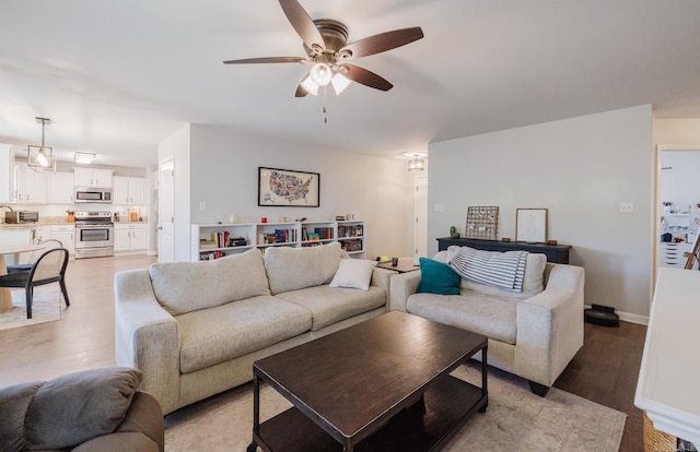 1324 Hunter Wood, Bryant, AR 72022 - living area with ceiling fan, light wood-type flooring, and baseboards