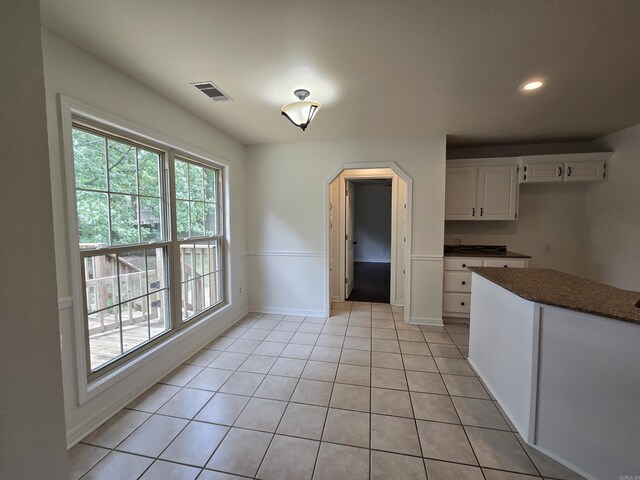 19 Twin Lks, Cabot, AR 72023 - kitchen featuring arched walkways, white cabinets, light tile patterned floors, baseboards, and recessed lighting
