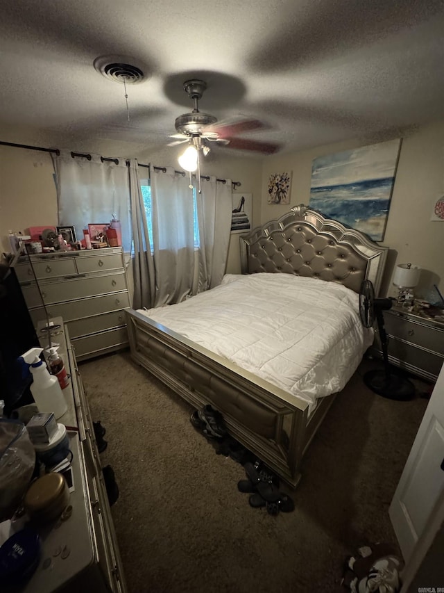 bedroom featuring carpet floors, a textured ceiling, and ceiling fan