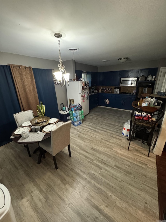 dining room featuring a chandelier and light wood finished floors