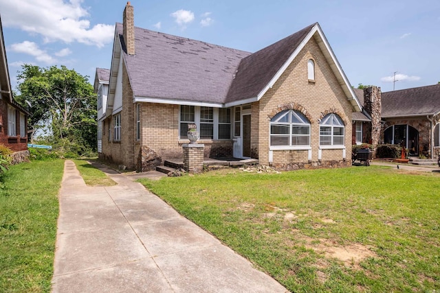 2815 Broadway St, Little Rock, AR 72206 - english style home featuring brick siding, a chimney, and a front yard