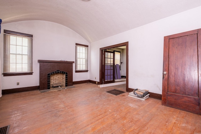 2815 Broadway St, Little Rock, AR 72206 - unfurnished living room with baseboards, wood finished floors, and vaulted ceiling
