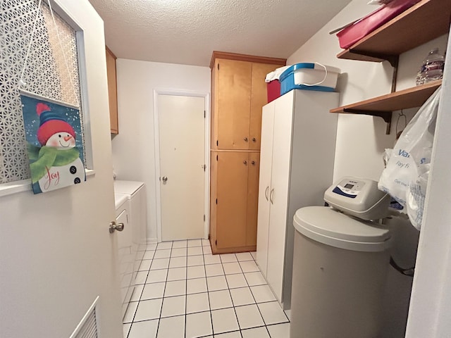 13 Many Moons Trce, Cherokee Village, AR 72529 - laundry room featuring cabinet space, washer and dryer, light tile patterned floors, and a textured ceiling