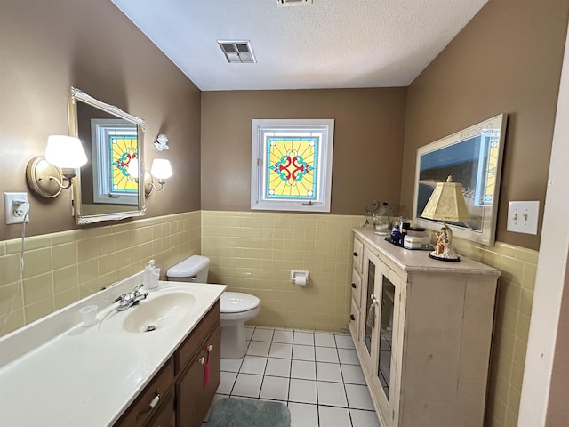 13 Many Moons Trce, Cherokee Village, AR 72529 - bathroom with tile walls, tile patterned flooring, a wainscoted wall, toilet, and vanity