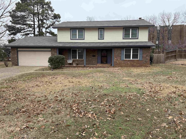 traditional-style house featuring a garage, brick siding, dirt driveway, and a porch