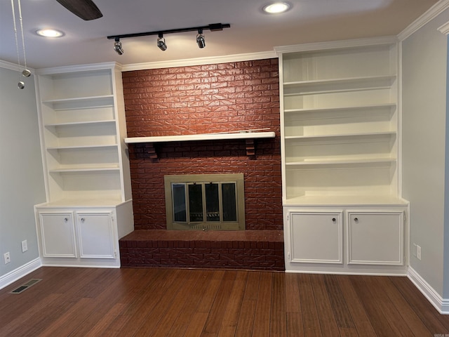 unfurnished living room with dark wood-style floors, baseboards, and a brick fireplace