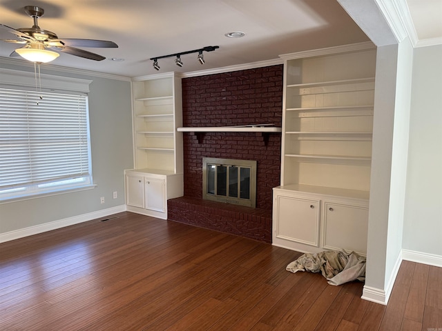 unfurnished living room with dark wood-style flooring, ceiling fan, baseboards, and a brick fireplace