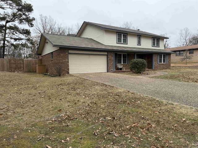 traditional home featuring brick siding, a garage, driveway, and covered porch