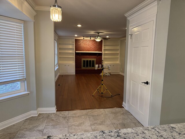 corridor featuring baseboards, ornamental molding, built in features, and recessed lighting