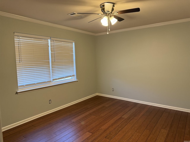 empty room with a ceiling fan, dark wood-type flooring, ornamental molding, and baseboards
