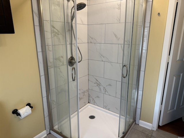 bathroom featuring a stall shower, baseboards, and tile patterned floors
