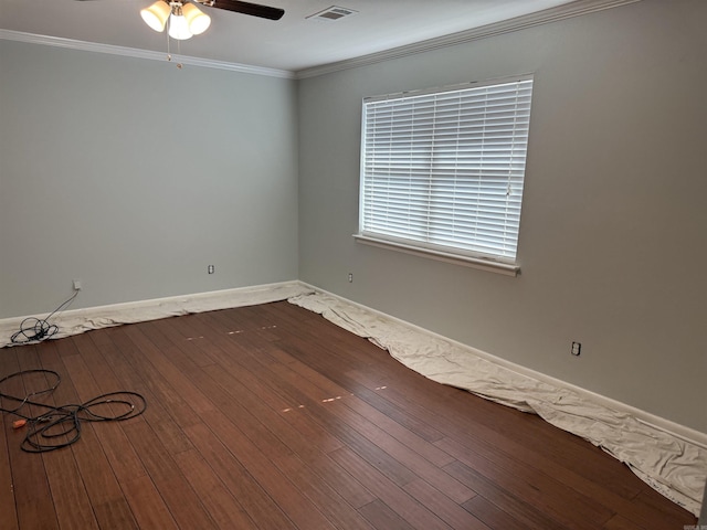 spare room with wood-type flooring, ceiling fan, crown molding, and baseboards