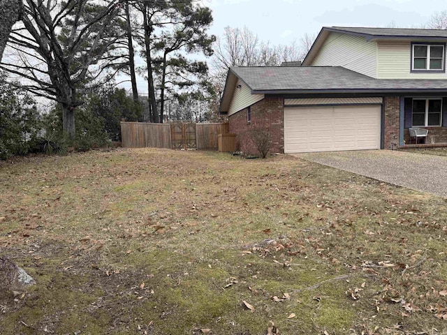view of side of home featuring brick siding, driveway, and a garage
