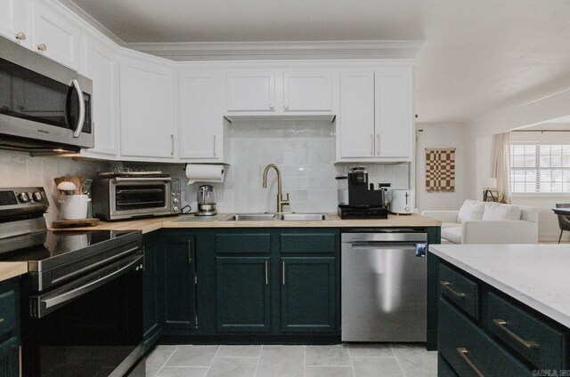 6873 Brazil Rd, Benton, AR 72019 - kitchen with stainless steel appliances, a sink, white cabinetry, and light countertops