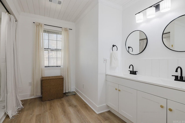 6873 Brazil Rd, Benton, AR 72019 - bathroom with ornamental molding, double vanity, wood finished floors, and baseboards