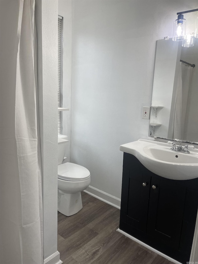6873 Brazil Rd, Benton, AR 72019 - bathroom with wood finished floors, vanity, toilet, baseboards, and curtained shower