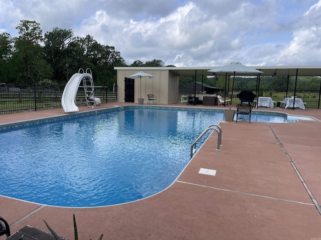 6873 Brazil Rd, Benton, AR 72019 - view of swimming pool with a water slide, a patio area, and outdoor lounge area