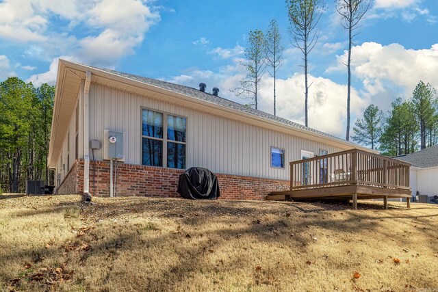 333 Maderas Dr, Hot Springs Village, AR 71909 - view of side of property featuring brick siding, a wooden deck, board and batten siding, central AC unit, and a shingled roof
