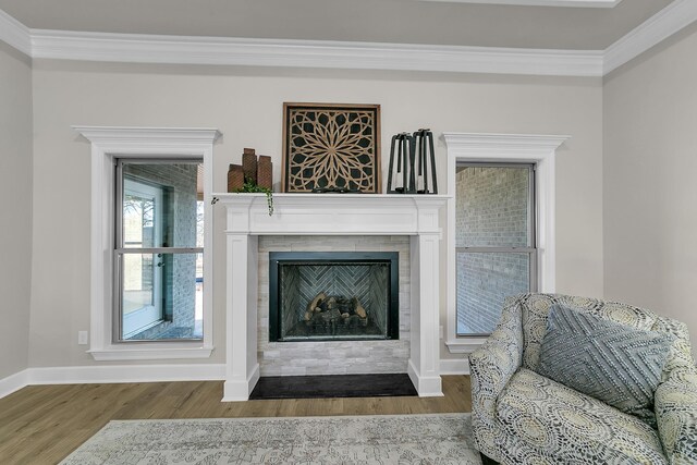 50 Wellington Pl, Cabot, AR 72023 - living room with wood finished floors, crown molding, baseboards, and a fireplace with flush hearth