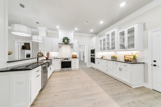 50 Wellington Pl, Cabot, AR 72023 - kitchen featuring appliances with stainless steel finishes, a sink, decorative backsplash, ornamental molding, and glass insert cabinets