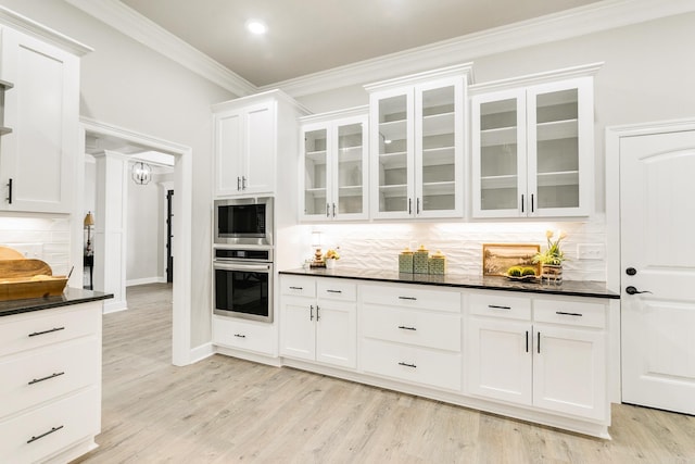 50 Wellington Pl, Cabot, AR 72023 - kitchen featuring appliances with stainless steel finishes, crown molding, decorative backsplash, white cabinets, and glass insert cabinets
