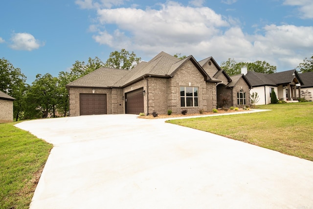 50 Wellington Pl, Cabot, AR 72023 - french provincial home featuring a garage, brick siding, a front lawn, and concrete driveway