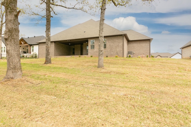 50 Wellington Pl, Cabot, AR 72023 - rear view of property featuring a yard, a shingled roof, and brick siding