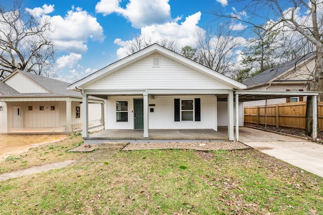 3317 W 7th St, Little Rock, AR 72205 - view of front of house featuring concrete driveway, an attached carport, board and batten siding, and covered porch