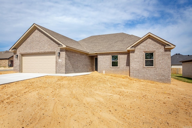 5201 Canter Ln, Jacksonville, AR 72076 - view of front of property featuring brick siding, a garage, concrete driveway, and a shingled roof