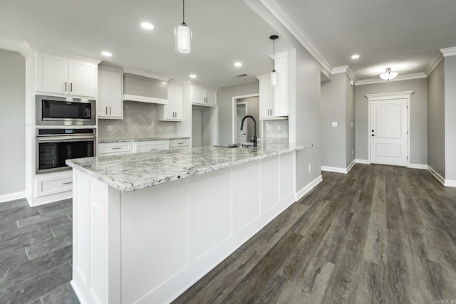 5201 Canter Ln, Jacksonville, AR 72076 - kitchen featuring appliances with stainless steel finishes, a sink, decorative backsplash, white cabinetry, and a peninsula