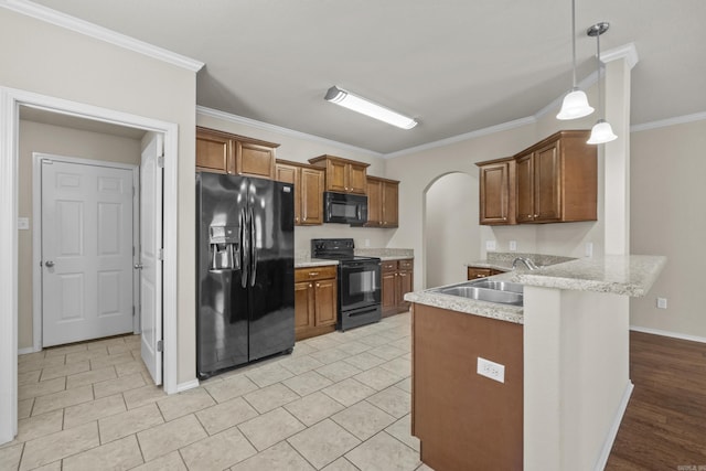 4114 Valles Rd, North Little Rock, AR 72118 - kitchen with black appliances, a peninsula, a sink, ornamental molding, and brown cabinetry