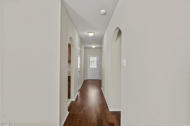4114 Valles Rd, North Little Rock, AR 72118 - hall featuring arched walkways, dark wood finished floors, and baseboards