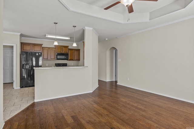 4114 Valles Rd, North Little Rock, AR 72118 - kitchen with black appliances, a ceiling fan, arched walkways, brown cabinets, and light countertops