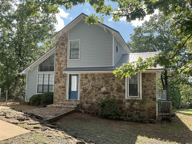 235 Sylvan Dr, Greers Ferry, AR 72067 - view of front facade with stone siding, entry steps, and metal roof