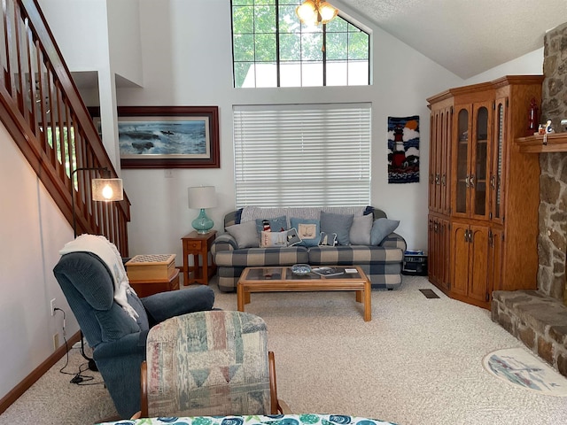 235 Sylvan Dr, Greers Ferry, AR 72067 - living room featuring carpet floors, vaulted ceiling, and stairway