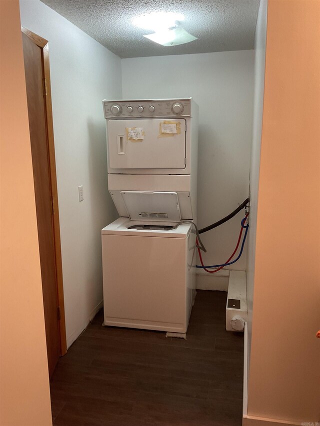 235 Sylvan Dr, Greers Ferry, AR 72067 - laundry room with stacked washer / dryer, dark wood finished floors, and a textured ceiling
