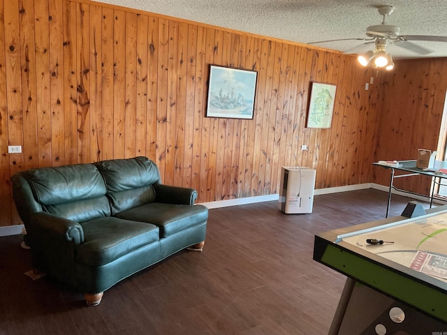 235 Sylvan Dr, Greers Ferry, AR 72067 - rec room with ceiling fan, wood walls, baseboards, wood finished floors, and a textured ceiling