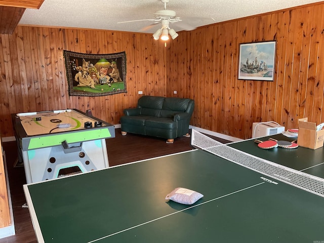 235 Sylvan Dr, Greers Ferry, AR 72067 - game room featuring wood finished floors, wooden walls, a ceiling fan, ornamental molding, and a textured ceiling