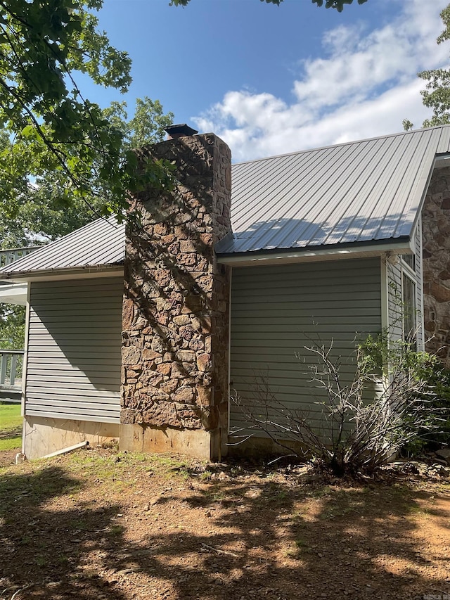 235 Sylvan Dr, Greers Ferry, AR 72067 - view of side of property featuring metal roof, stone siding, and a chimney