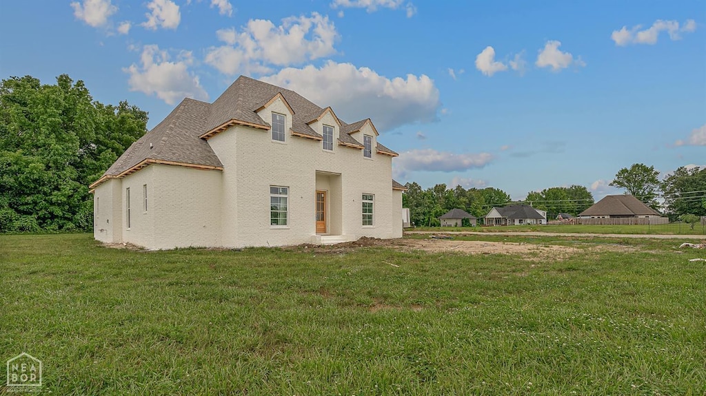 149 County Road 7127, Jonesboro, AR 72405 - view of front of house with a front yard, stucco siding, and roof with shingles