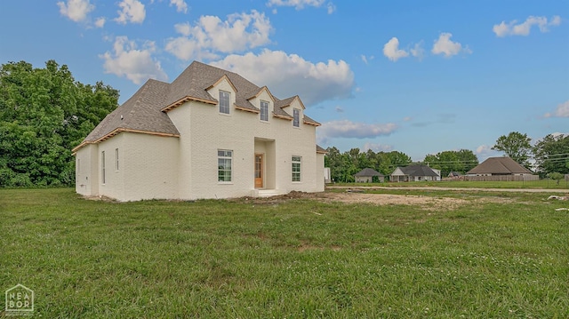 149 County Road 7127, Jonesboro, AR 72405 - view of front of house with a front yard, stucco siding, and roof with shingles